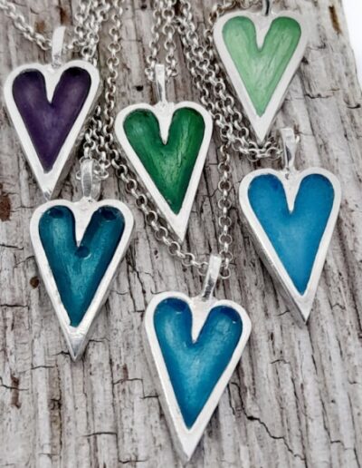 enamelled heart pendants in blues, greens and purple