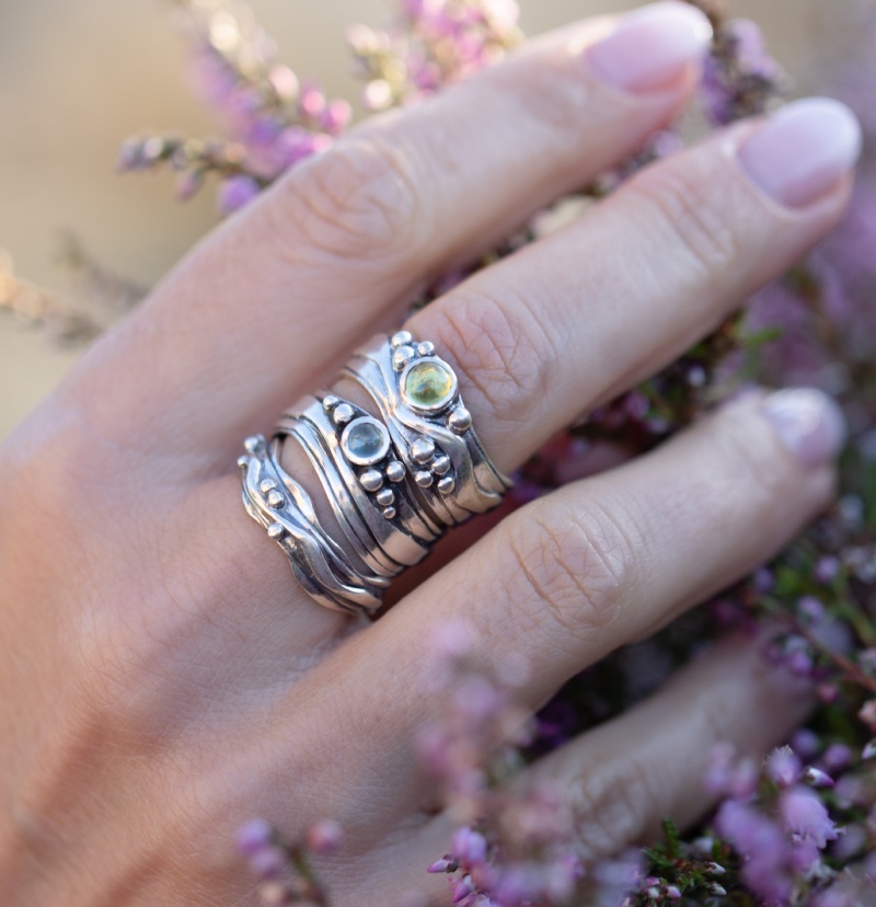 stack of narrow wave rings in silver with gems